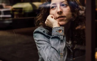 Woman looking out of a coffee shop window