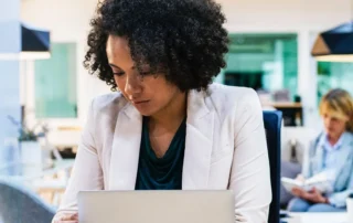 woman on laptop and on cell phone