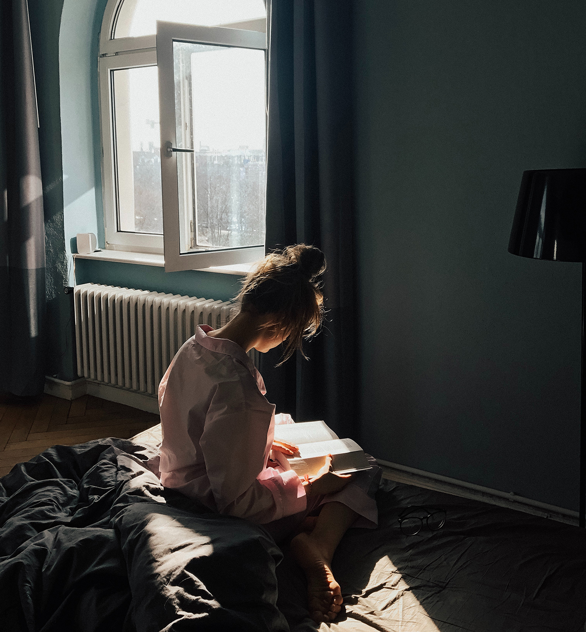 woman reading book by sunlight