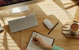 Woman at computer with notepad