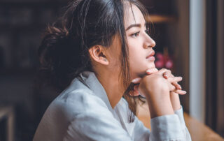woman lost in thought looking out window