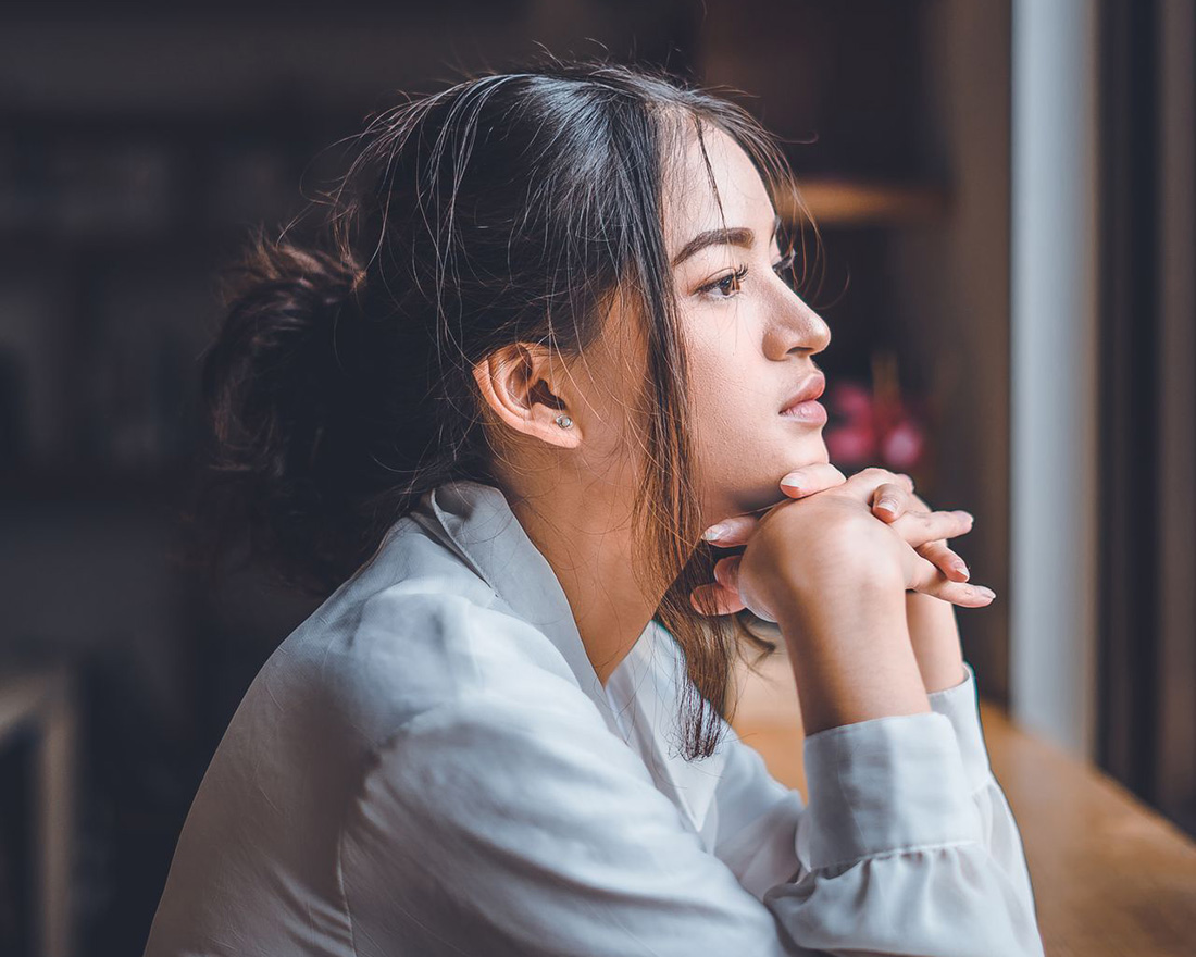 woman lost in thought looking out window